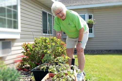 Resident tending to plants in the garden