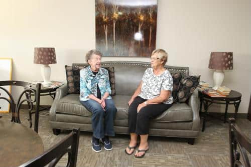 Two residents enjoying a conversation in the lounge