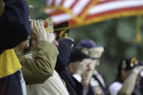 Veterans saluting the flag at a ceremony