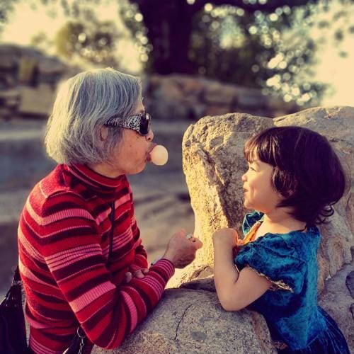 An elderly woman and a child enjoying outdoors