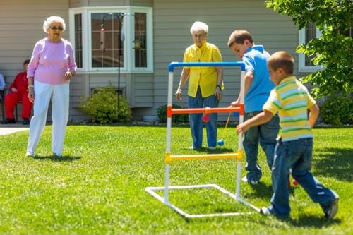 Residents and children playing a game in the garden