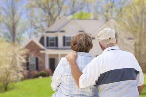 A couple enjoying a scenic view of a house