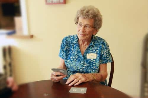Resident playing cards in a cozy interior space