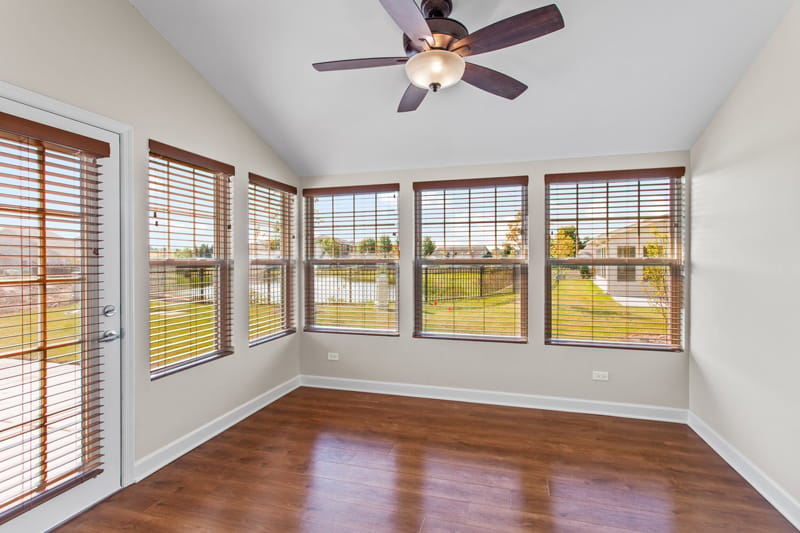 Bright interior room with large windows and wooden floor