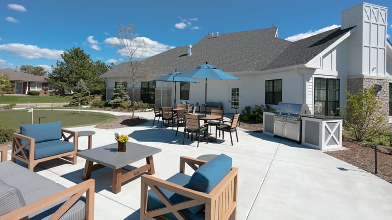 Outdoor patio area with seating and barbecue grill