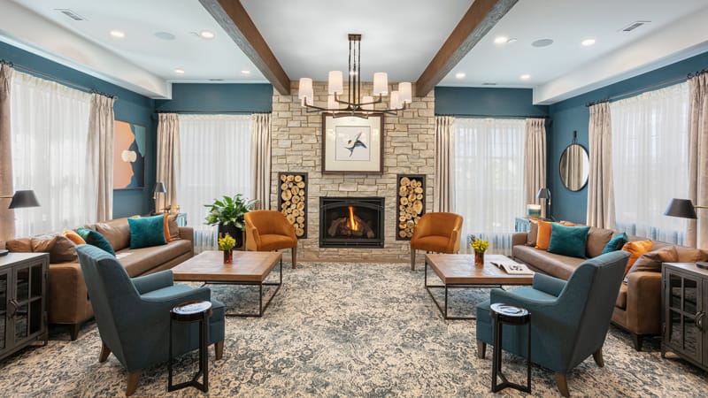 Warm and inviting common area with seating and fireplace