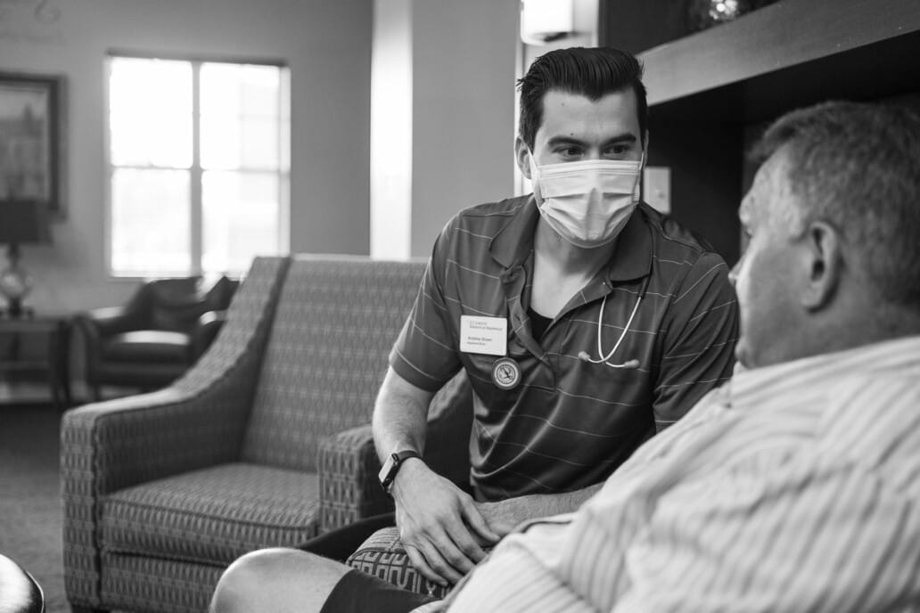 Staff member interacting with resident in a cozy common area