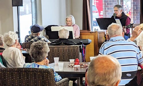 Residents enjoying a live music performance in a common area