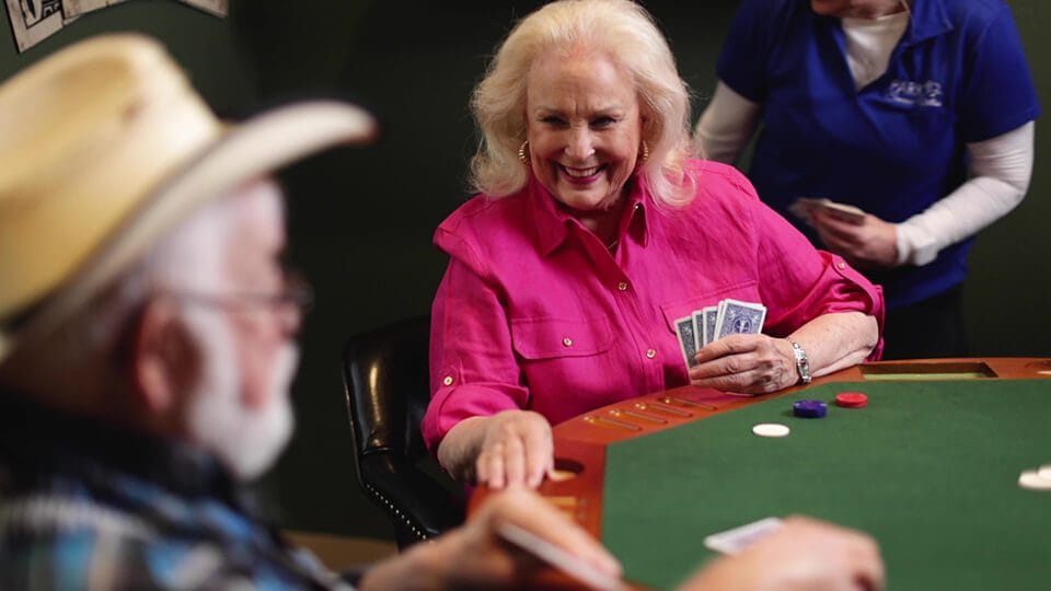 Residents enjoying a card game in a common area