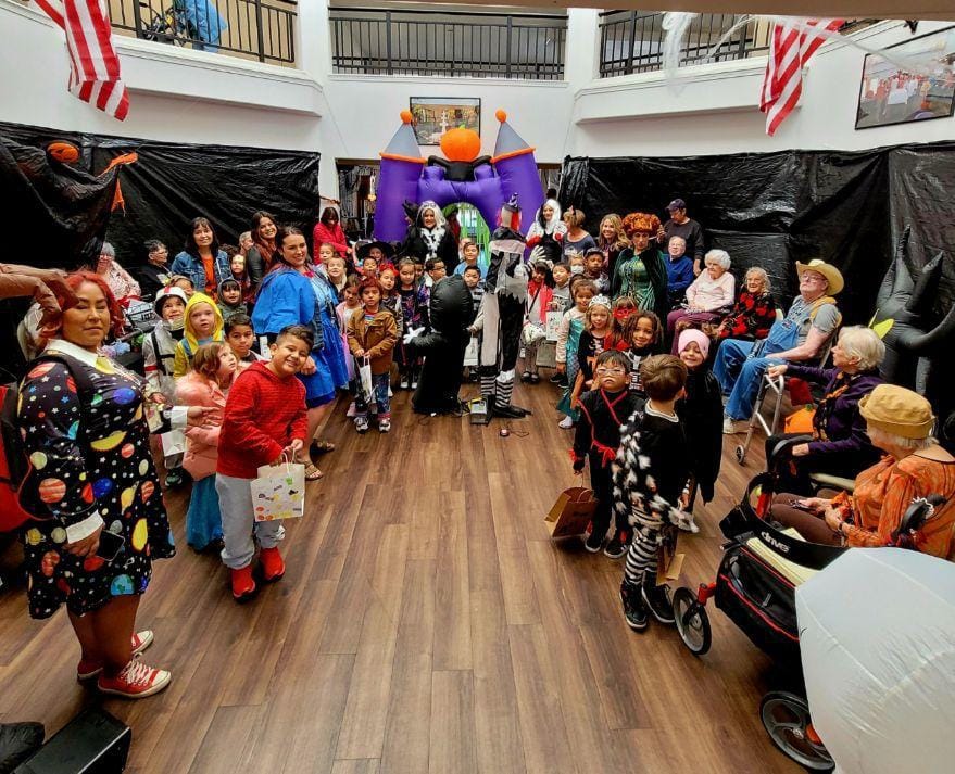 Residents and children celebrating in a common area