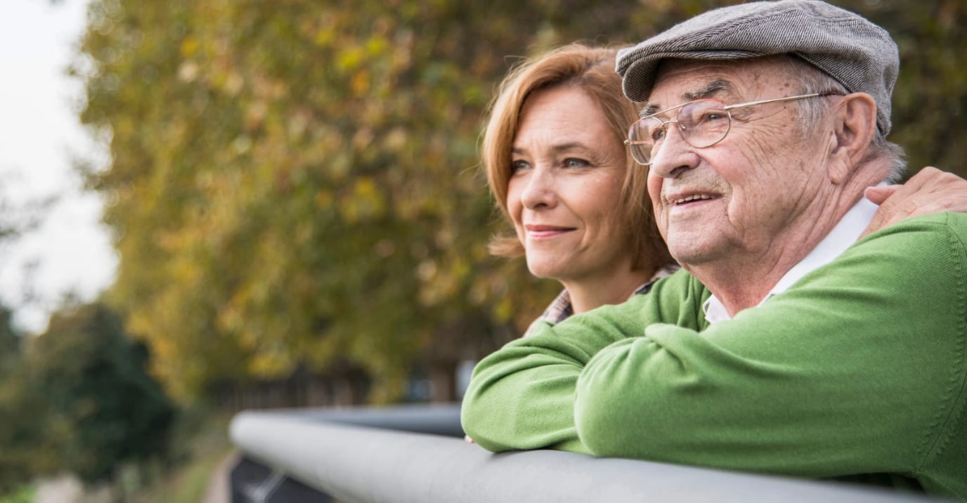 Elderly man and woman enjoying outdoors together.