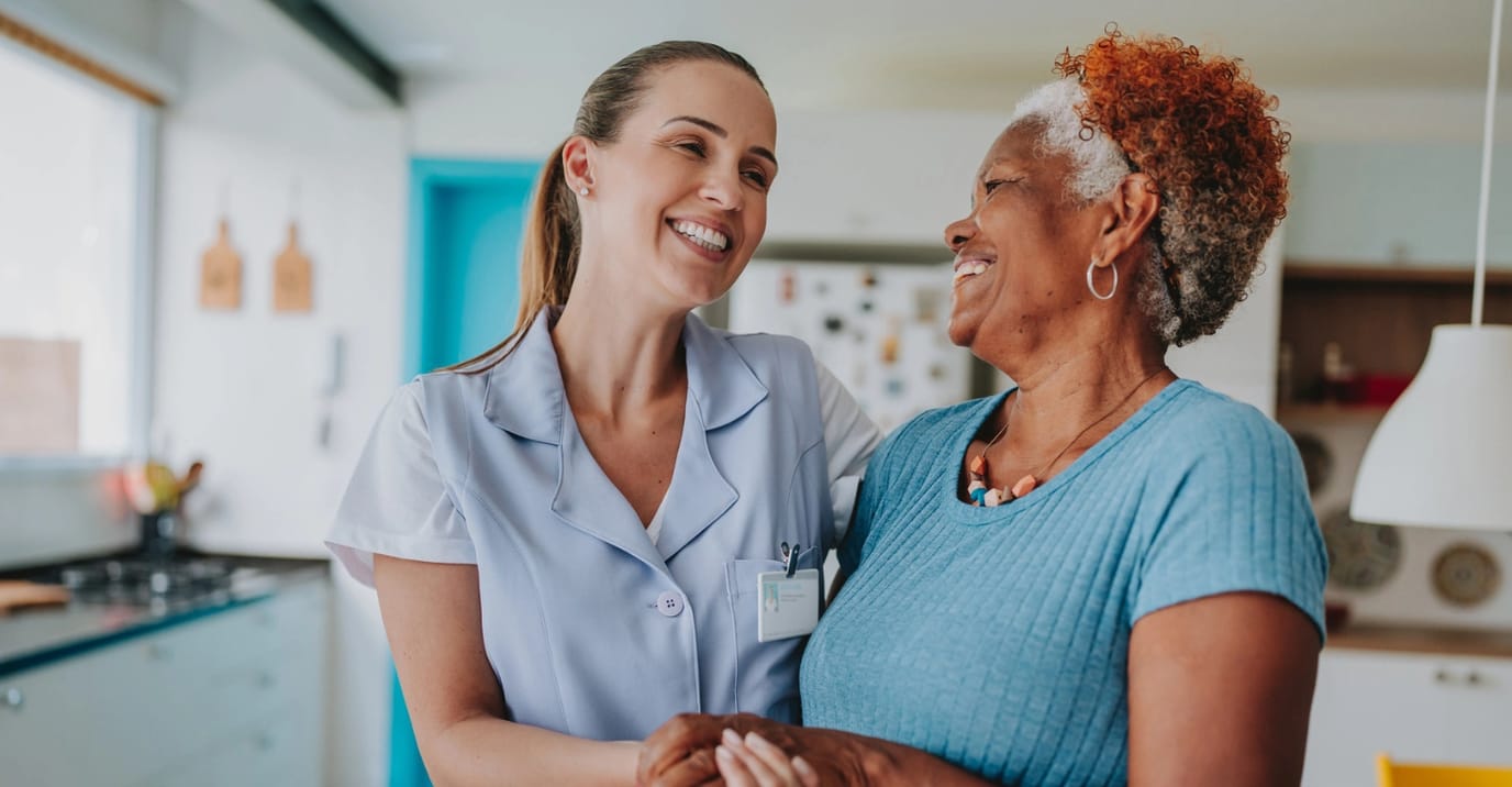Happy caregiver and resident sharing a moment.