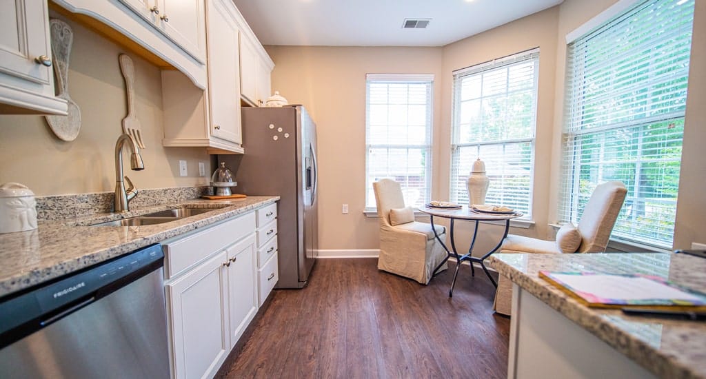 Bright kitchen area with dining space and windows