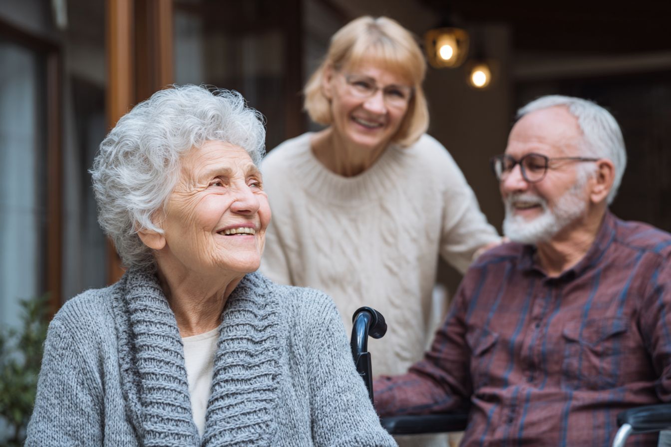 Three residents interacting and smiling together