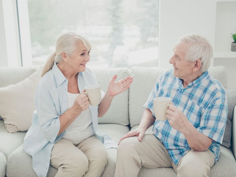Two residents enjoying conversation on a sofa