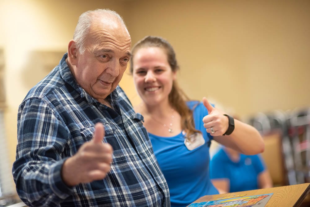 Resident and staff member enjoying an activity together