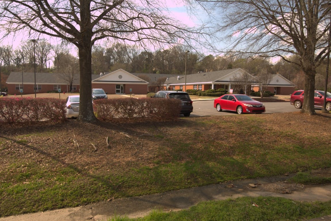 Exterior view of Country Cottage Huntsville with parked cars