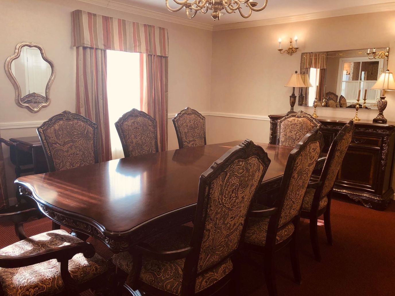 Dining room with a wooden table and ornate chairs