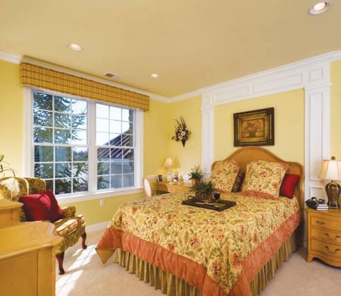 Well-decorated bedroom featuring floral bedding and ample natural light.