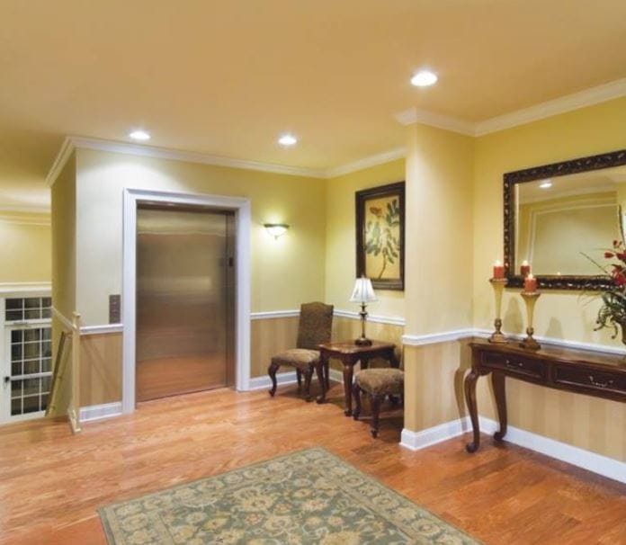 Cozy elevator lobby with seating and decorative elements