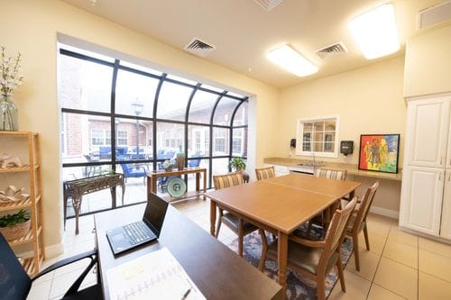 Bright community room with a large table and windows