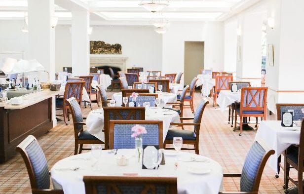 Spacious dining area with tables set for dining at Heritage on the Marina.