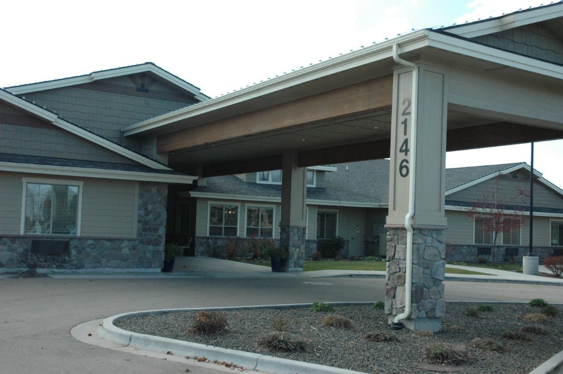 Entrance of The Cottages at Lochsa Falls with stone pillars and numbered sign