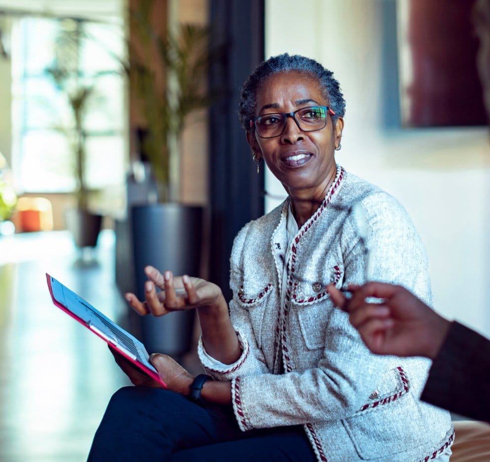 Resident engaged in conversation in a well-lit lounge