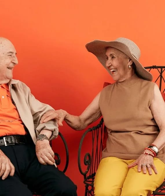 Two smiling seniors enjoying each other's company