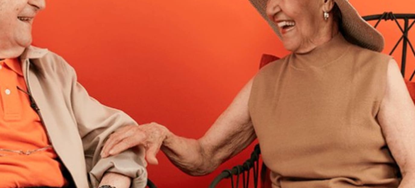 Two elderly individuals enjoying each other's company
