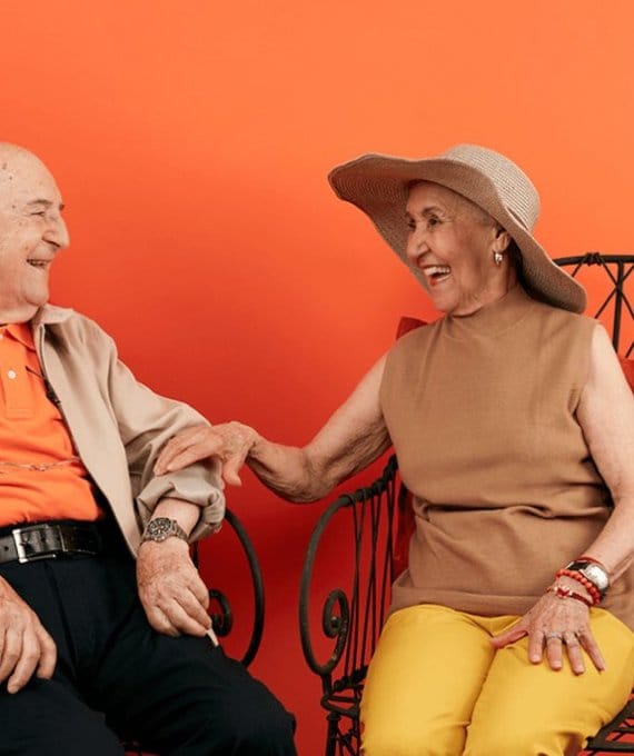 Two seniors smiling and enjoying each other's company