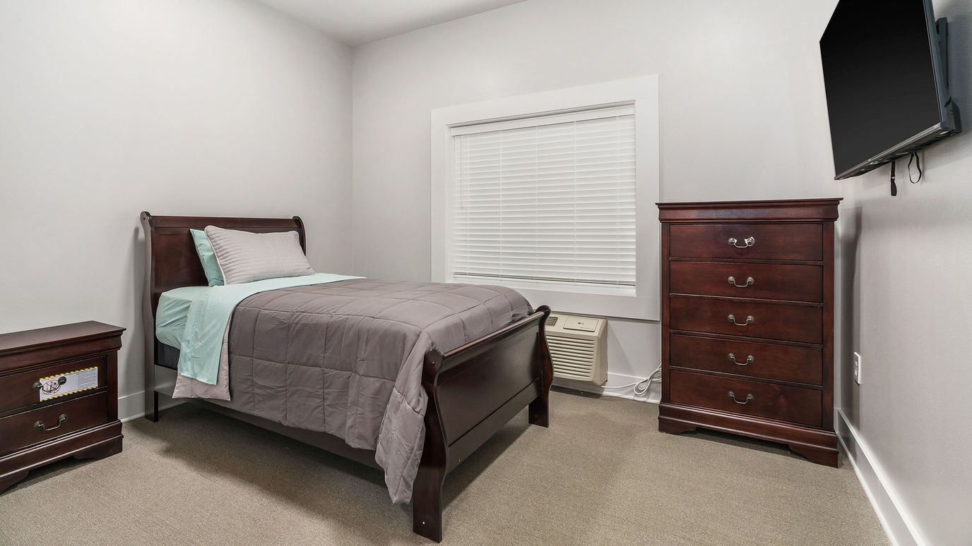 Private resident room with a bed and dresser