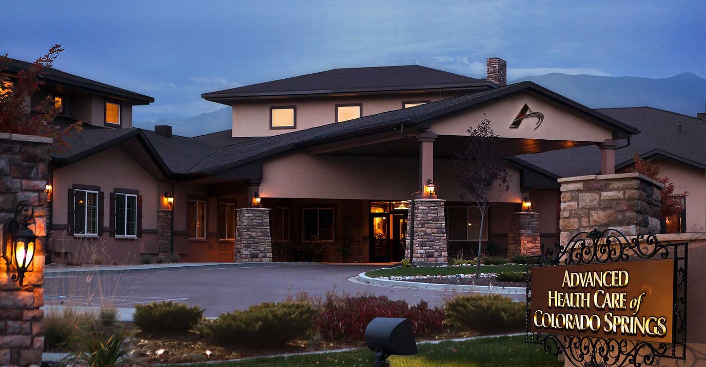 Exterior view of a senior care facility at dusk.