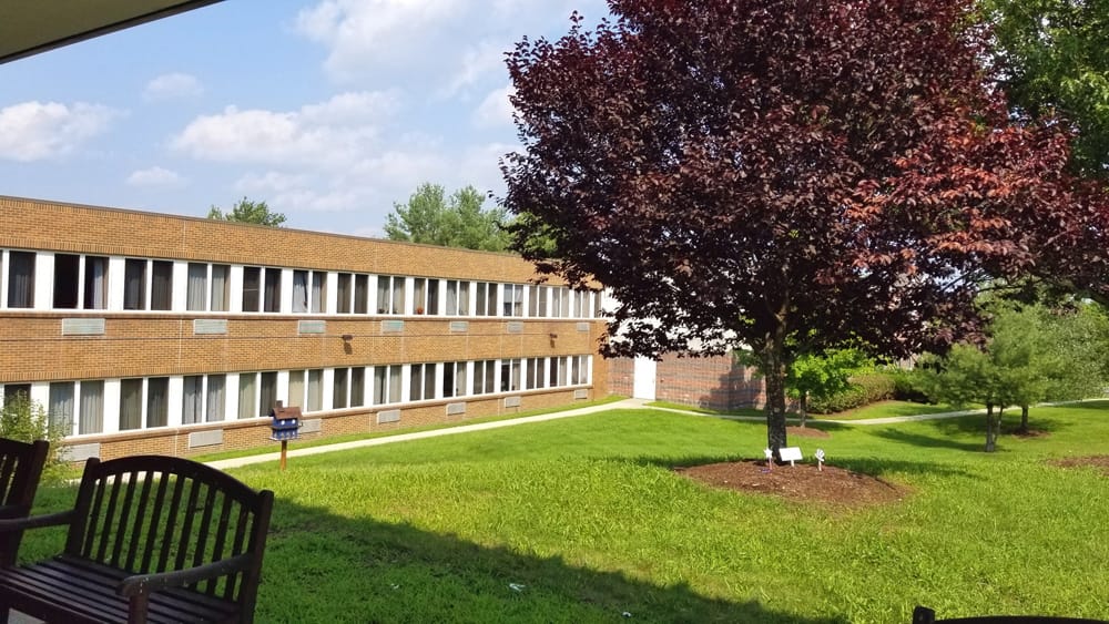 Exterior view of Southtowns Care Center with lawn and trees.