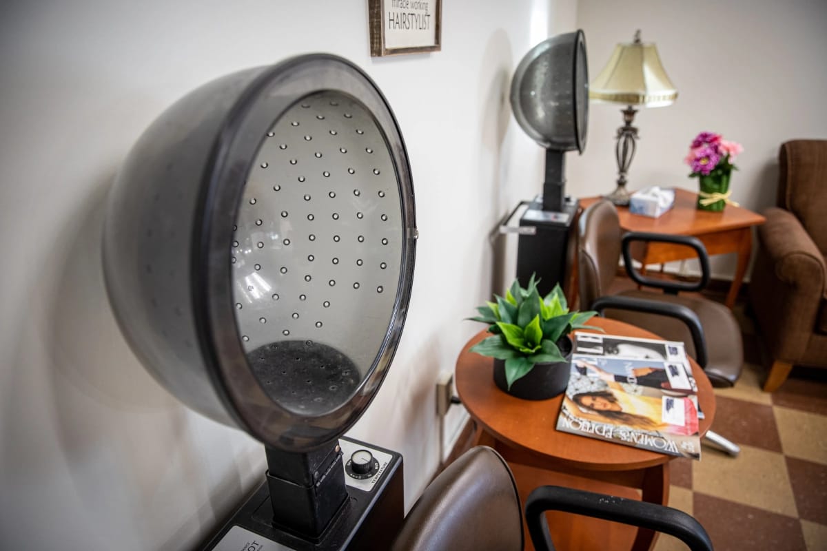 Interior salon area with hair dryers and seating