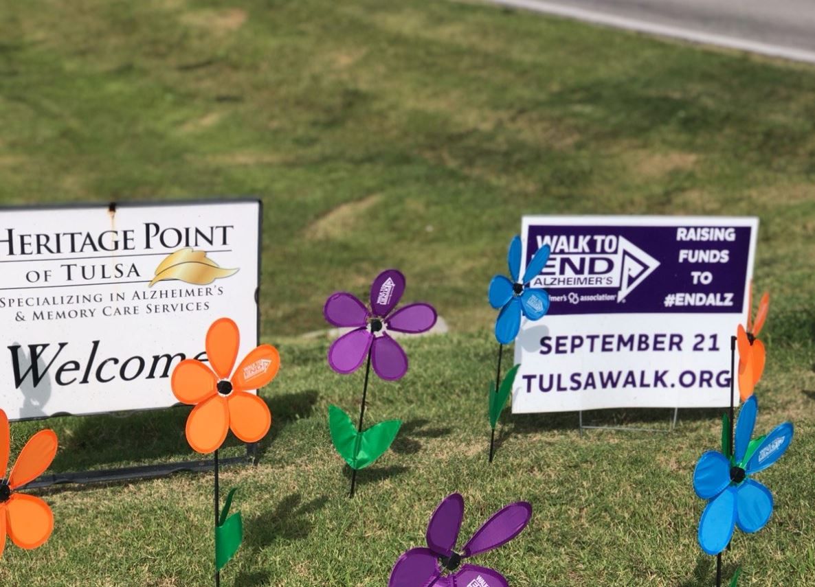 Colorful flower decorations alongside welcome and event signs
