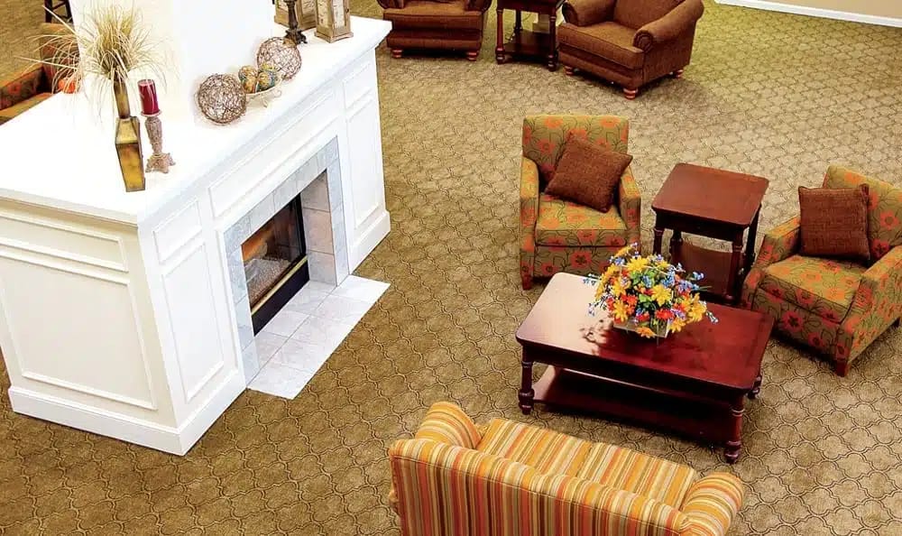 Lounge area featuring a fireplace, seating, and floral arrangement