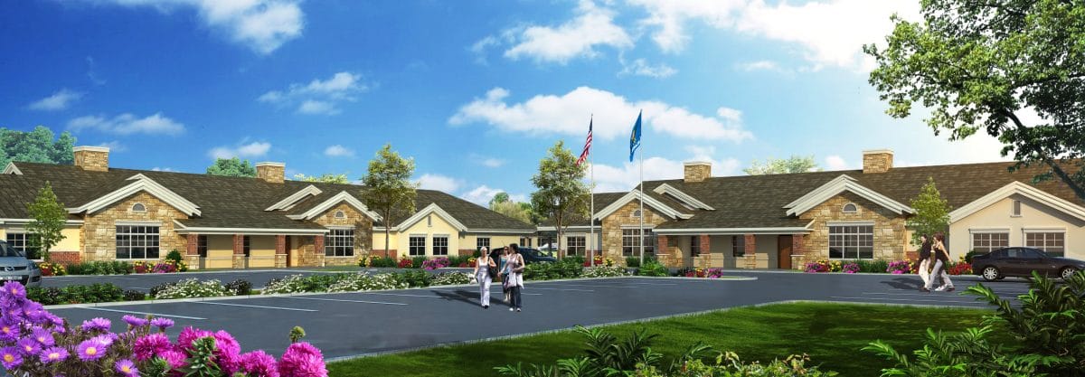 Exterior of The Heritage of Overland Park with flowers and flagpoles