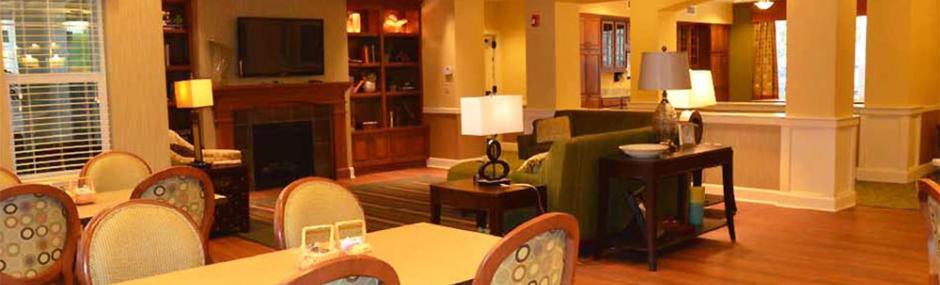 Lounge area with seating, lamps, and a fireplace