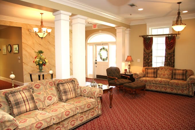 A comfortable living room with sofas and a welcoming entrance.