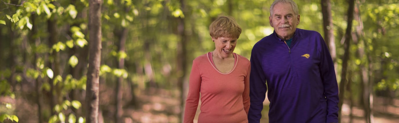 Residents walking together in a wooded area