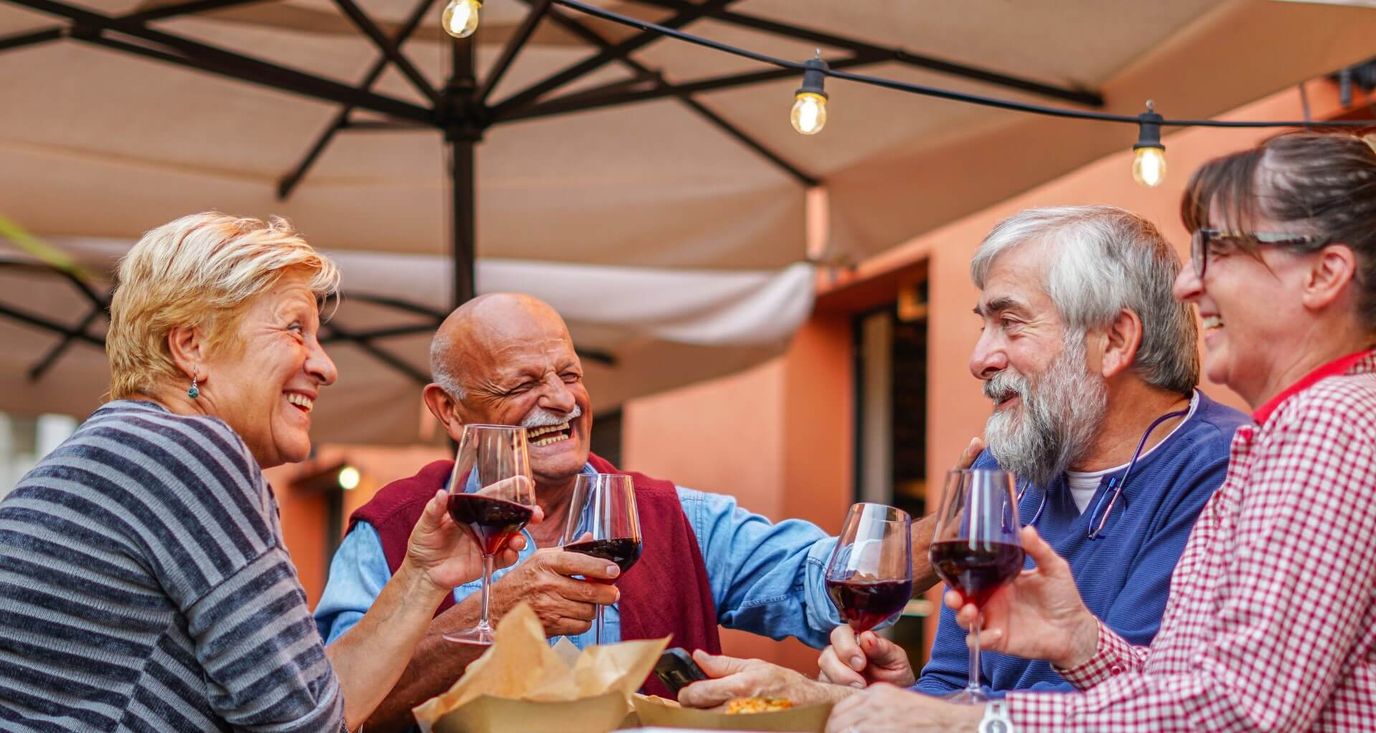 Residents enjoying wine together outdoors