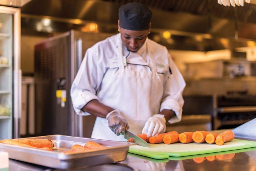 Chef preparing carrots in the kitchen