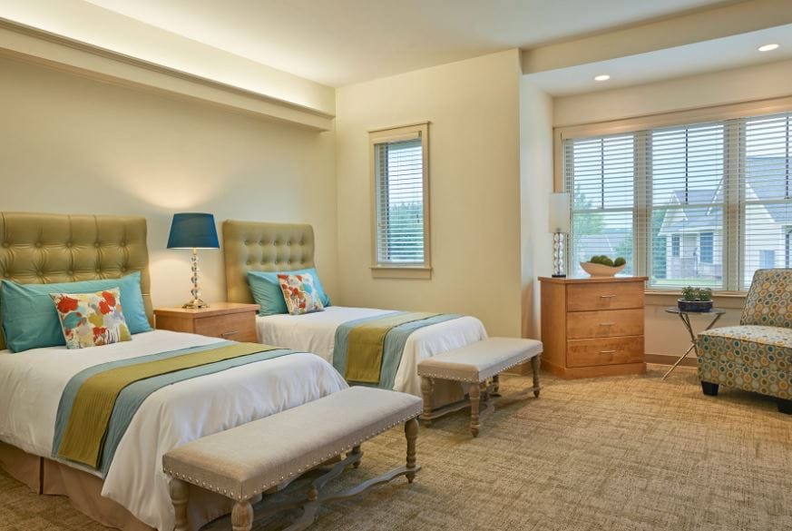 Well-lit bedroom with two beds and modern decor