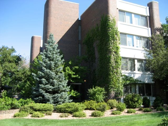 Exterior of the Heritage of Edina building with greenery and landscaping.