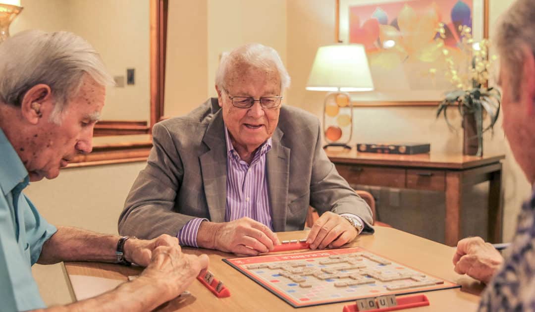 Residents enjoying a game of Scrabble in a common area