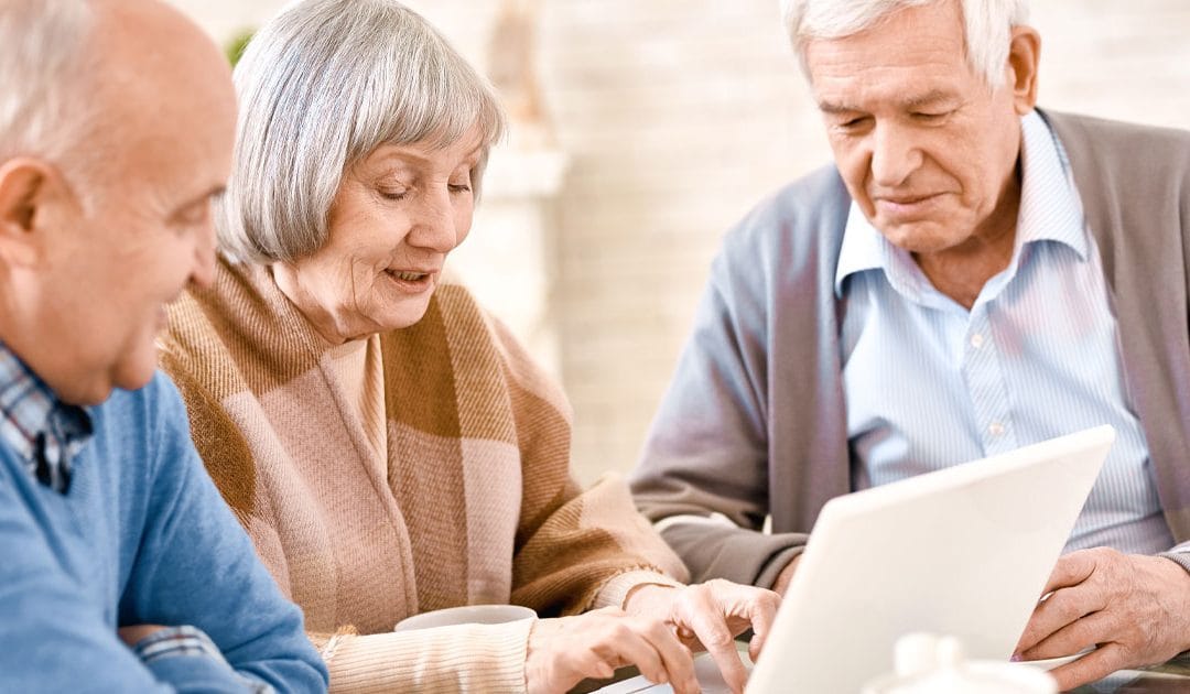 Residents engaged in an activity around a laptop