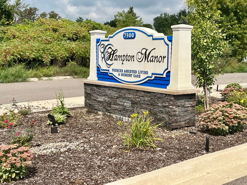 Sign for Hampton Manor of Hamburg showcasing name and services