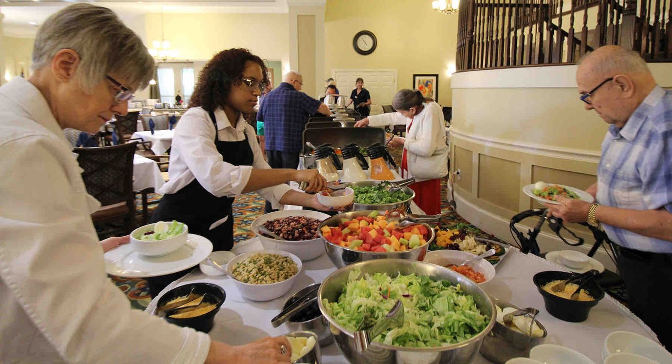 Residents enjoying a meal service in the dining room