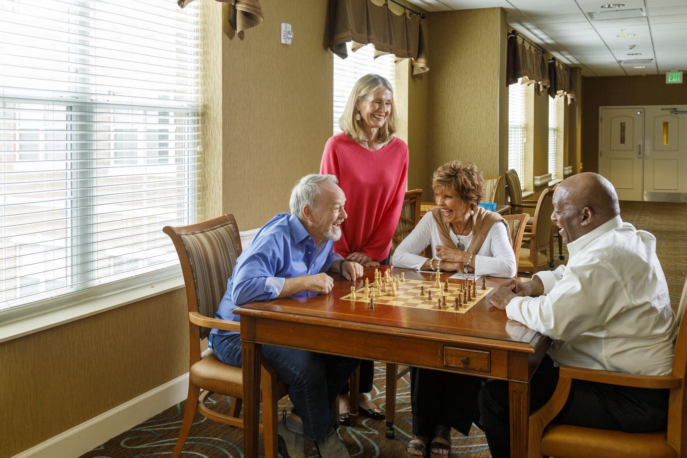 Residents playing chess in a bright common area